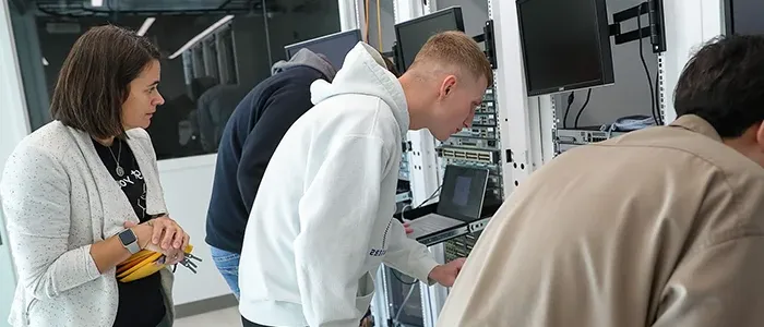 an instructor observes students working on servers